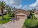 Attractive single-Gathering home with brick driveway, mature palm trees, and well-maintained landscaping at 4327 Gullane Dr, Lake Wales, FL 33859