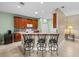 Kitchen bar area with granite countertops, wood cabinetry, and seating for three at 4327 Gullane Dr, Lake Wales, FL 33859