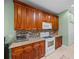 Kitchen features granite countertops, tiled backsplash, and wood cabinets at 4327 Gullane Dr, Lake Wales, FL 33859