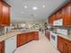 Spacious kitchen featuring granite countertops, stainless steel appliances, and warm wood cabinetry at 4327 Gullane Dr, Lake Wales, FL 33859
