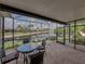 Screened-in lanai overlooking the water with an outdoor seating area, offering tranquil views and ample space at 4327 Gullane Dr, Lake Wales, FL 33859