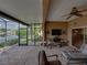 Enclosed lanai features a view of the water, outdoor bar area, and access to the kitchen through sliding glass doors at 4327 Gullane Dr, Lake Wales, FL 33859