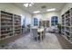 Library featuring floor-to-ceiling bookshelves, a table with chairs, and abundant natural light at 4327 Gullane Dr, Lake Wales, FL 33859