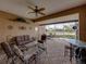 Covered patio with comfortable seating and a serene view of the water and neighborhood at 4327 Gullane Dr, Lake Wales, FL 33859