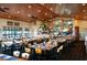 Restaurant with wooden tables and chairs, a full bar, and a cozy atmosphere with wood-paneled walls at 4327 Gullane Dr, Lake Wales, FL 33859