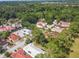 Aerial view of a residential neighborhood surrounded by lush greenery and mature trees at 441 San Jose Dr, Winter Haven, FL 33884