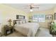 Comfortable bedroom featuring warm yellow walls, a ceiling fan, and ample natural light at 441 San Jose Dr, Winter Haven, FL 33884