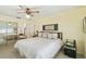 Bedroom featuring warm yellow walls, comfortable bed, and sliding door closet at 441 San Jose Dr, Winter Haven, FL 33884
