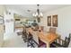 Open dining room with large wooden table and seating for eight guests at 441 San Jose Dr, Winter Haven, FL 33884