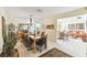 Formal dining room featuring a chandelier and an elegant table set, adjacent to the living room at 441 San Jose Dr, Winter Haven, FL 33884