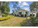 Charming single-story home with a well-manicured lawn, green awnings, and mature trees at 441 San Jose Dr, Winter Haven, FL 33884
