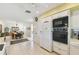 Bright kitchen with white appliances, tile flooring, and open layout at 441 San Jose Dr, Winter Haven, FL 33884