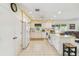 Bright kitchen featuring tile floors, white appliances, and ample cabinet space at 441 San Jose Dr, Winter Haven, FL 33884