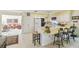 The kitchen has a breakfast bar, white cabinetry, and flows into the living area at 441 San Jose Dr, Winter Haven, FL 33884