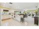 Spacious kitchen with white cabinets, barstool seating, and easy access to the living room at 441 San Jose Dr, Winter Haven, FL 33884