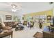 Bright living room featuring a leather sofa, ceiling fan, and natural light at 441 San Jose Dr, Winter Haven, FL 33884