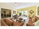 Cozy living room with high ceilings adjacent to a dining area and a view of the patio at 441 San Jose Dr, Winter Haven, FL 33884