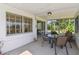 Enclosed patio features neutral toned furniture, view to the garden, and plenty of natural light at 441 San Jose Dr, Winter Haven, FL 33884