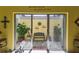 Enclosed patio with garden decor, a cozy bench, and sliding glass doors at 441 San Jose Dr, Winter Haven, FL 33884