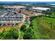 Wide aerial shot of the community, lake, and nearby commercial buildings at 476 Haines Trl, Winter Haven, FL 33881