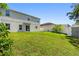 An expansive backyard with a well-maintained lawn offers plenty of space for outdoor activities at 476 Haines Trl, Winter Haven, FL 33881