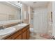 Bright bathroom with double sinks, a shower, and coordinated fixtures at 476 Haines Trl, Winter Haven, FL 33881