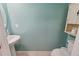 Well-lit powder room with a neutral color palette and pedestal sink, offering a tranquil space at 476 Haines Trl, Winter Haven, FL 33881