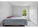A simply decorated bedroom with closet and view of mature trees at 476 Haines Trl, Winter Haven, FL 33881