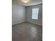 Empty bedroom featuring tile floors, a window for natural light and neutral colored walls at 476 Haines Trl, Winter Haven, FL 33881