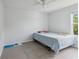 Simple bedroom features neutral walls, ceiling fan, and window letting in natural light at 476 Haines Trl, Winter Haven, FL 33881