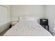 Bedroom featuring a white bed with a floral comforter and a mini fridge at 476 Haines Trl, Winter Haven, FL 33881