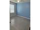 Empty bedroom featuring gray tile, a ceiling fan, and a window for natural light at 476 Haines Trl, Winter Haven, FL 33881