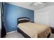 Bright bedroom with blue accent wall, ceiling fan, and large window at 476 Haines Trl, Winter Haven, FL 33881