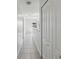 Bright hallway featuring white walls and tile flooring at 476 Haines Trl, Winter Haven, FL 33881