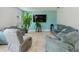 Living room with tile floors and large TV at 476 Haines Trl, Winter Haven, FL 33881