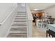 Staircase to the second floor, leading to an open kitchen and dining space at 476 Haines Trl, Winter Haven, FL 33881