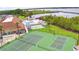 Aerial view showcasing the beautiful community amenities including the tennis courts, swimming pool, and a serene lakeside retreat at 492 Sweetwater Way, Haines City, FL 33844