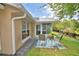 Backyard patio area with landscaping, perfect for enjoying outdoor living near a sunroom at 492 Sweetwater Way, Haines City, FL 33844