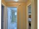 Hallway view into bathroom, with tile floors and glass enclosed shower at 492 Sweetwater Way, Haines City, FL 33844