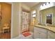 A well lit bathroom featuring a shower with printed curtain and tile flooring at 492 Sweetwater Way, Haines City, FL 33844