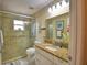 Bathroom featuring a glass shower, granite countertop, vanity, and neutral tile flooring at 492 Sweetwater Way, Haines City, FL 33844