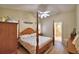 Spacious bedroom features an ensuite bathroom, ceiling fan, and beach-themed decor throughout at 492 Sweetwater Way, Haines City, FL 33844