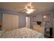 Cozy bedroom with an abundance of storage, a ceiling fan and blue accent walls at 492 Sweetwater Way, Haines City, FL 33844