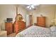 Bright and open bedroom featuring a four-poster bed, ceiling fan, with connecting bathroom at 492 Sweetwater Way, Haines City, FL 33844