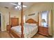 Well-lit bedroom with ceiling fan and four-poster bed is nicely decorated and includes ample storage at 492 Sweetwater Way, Haines City, FL 33844