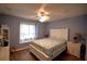 Charming bedroom featuring cool tones, a ceiling fan, and a window nook for comfortable seating at 492 Sweetwater Way, Haines City, FL 33844