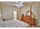 Large bedroom boasts a four-poster bed, dresser and a view into the ensuite bathroom at 492 Sweetwater Way, Haines City, FL 33844