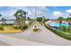 Gated community entrance with lush landscaping, offering security and a welcoming first impression for residents at 492 Sweetwater Way, Haines City, FL 33844