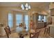 Bright dining room featuring large windows, hardwood flooring, and seating for four at 492 Sweetwater Way, Haines City, FL 33844