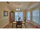 Bright dining room with large windows, vaulted ceilings, and a glass table at 492 Sweetwater Way, Haines City, FL 33844